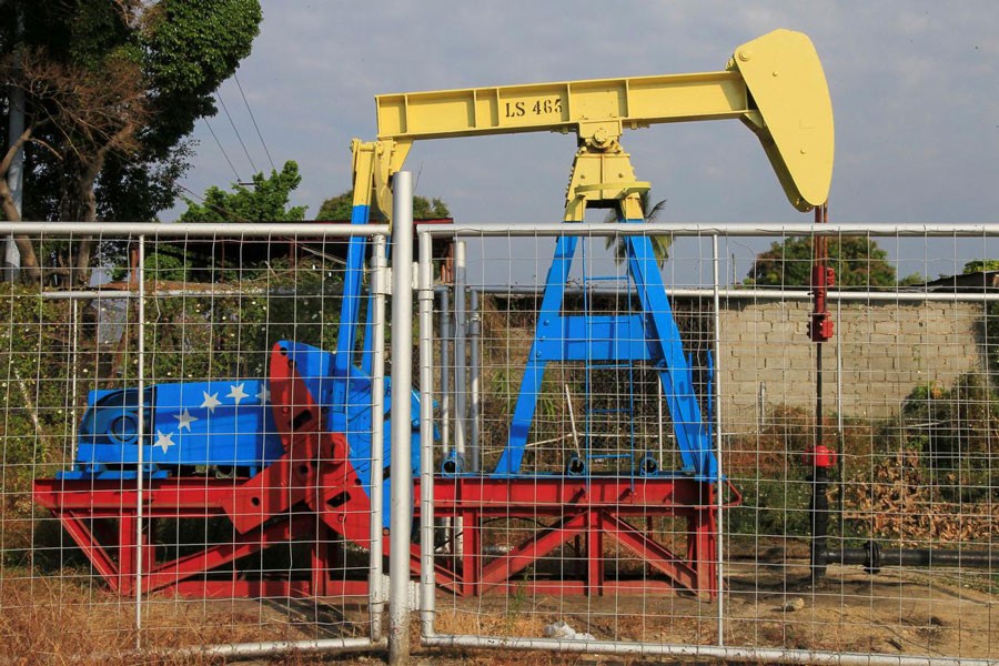 An oil pumpjack painted with the colors of the Venezuelan flag is seen in Lagunillas, Venezuela                    	— Reuters