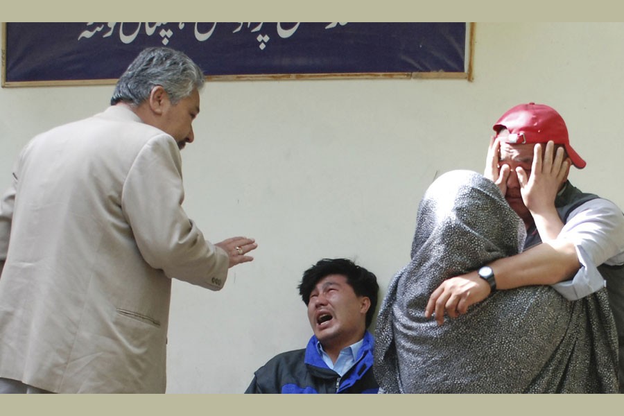 Family members of the blast victims comfort each other outside a mortuary in Quetta, Pakistan, Friday, April 12, 2019. A powerful bomb went off at an open-air market in the southwestern city of Quetta on Friday, police and hospital officials said - ARSHAD BUTT/AP photo