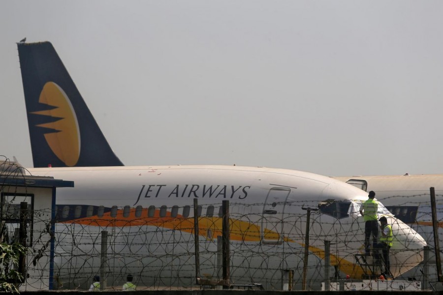 Workers cover the cockpit window of a Jet Airways aircraft parked at the Chhatrapati Shivaji Maharaj International Airport in Mumbai, India, March 26, 2019 - REUTERS/Francis Mascarenhas/File Photo