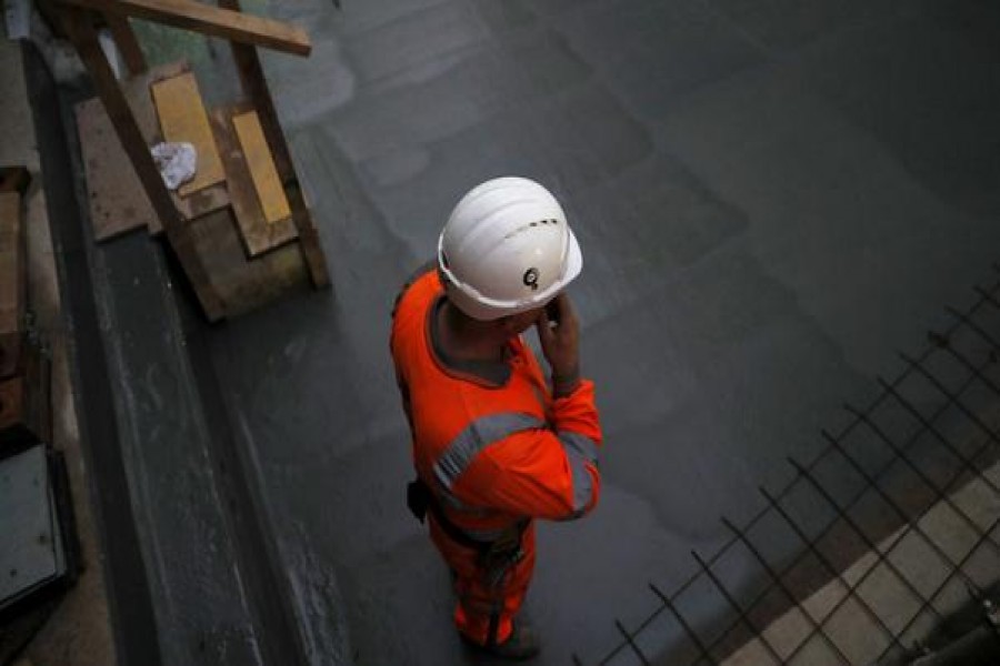 A construction worker stands on a concrete floor at the site for the new Crossrail station in Tottenham Court Road, in London, Britain, November 16, 2016. Reuters/Stefan Wermuth - Copyright Stefan Wermuth