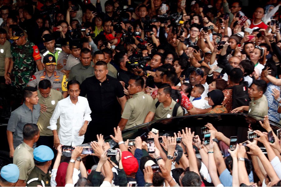 Indonesia's President Joko Widodo reacting after a quick count result during the Indonesian elections in Jakarta on Thursday	— Reuters