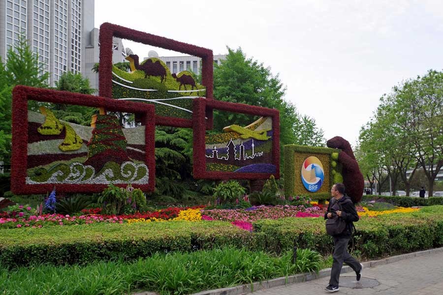 A man walking past a flower installation set up for the upcoming Belt and Road Forum in front of the Chinese Foreign Ministry in Beijing, China on April 18, 2019. -Reuters Photo