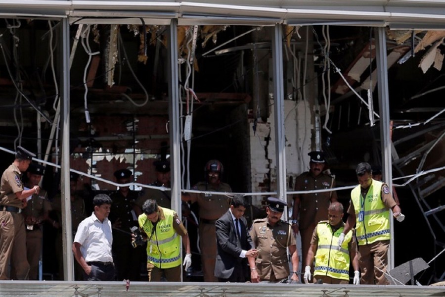 Crime scene officials inspect the explosion area at Shangri-La hotel in Colombo, Sri Lanka, April 21, 2019. Reuters
