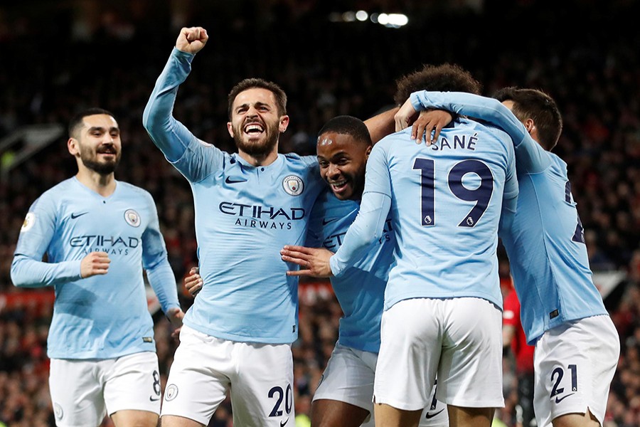 Manchester City's Leroy Sane celebrates scoring their second goal with Bernardo Silva and other teammates — Reuters Action Image