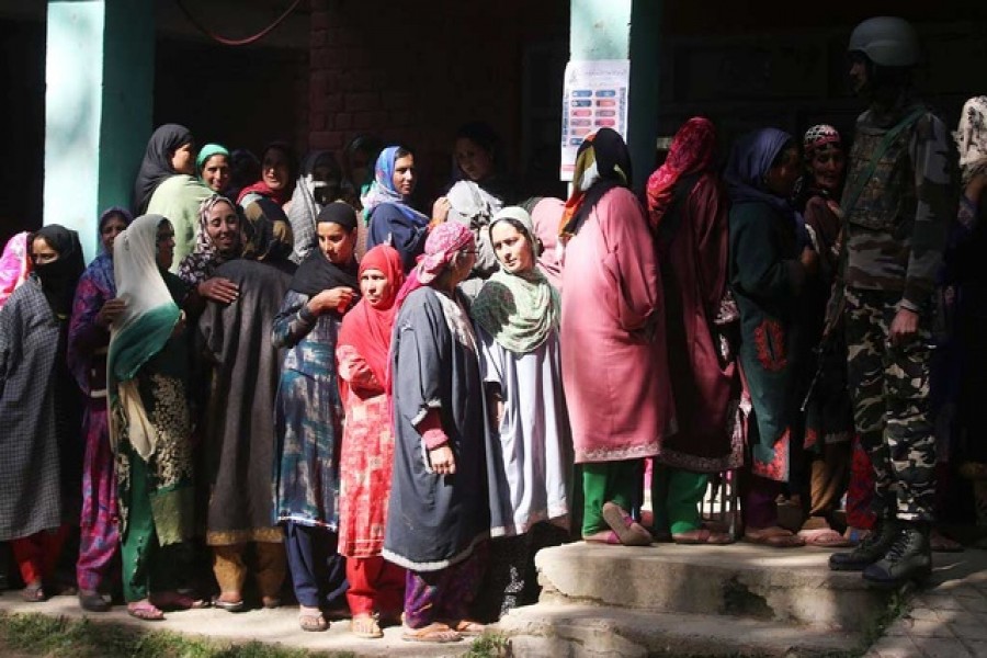 Women wait in a queue to cast their votes outside a polling station in Kund, in south Kashmir's Kulgam district, April 29, 2019. Reuters