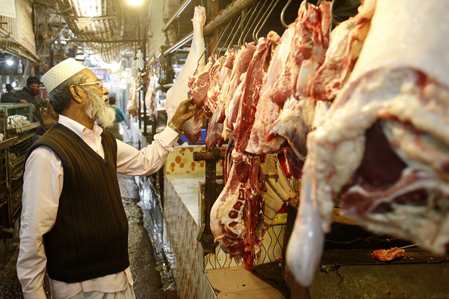 A potential customer checks beef cuts at a bazar in Dhaka's Khilgaon area — Focus Bangla/Files