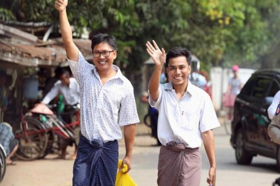 Reuters reporters Wa Lone and Kyaw Soe Oo gesture as they walk free outside Insein prison after receiving a presidential pardon in Yangon, Myanmar, May 7, 2019. Reuters/Files