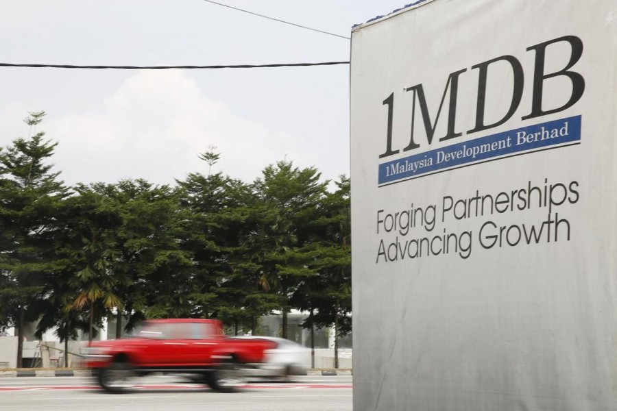 Traffic passes a 1Malaysia Development Berhad (1MDB) billboard at the Tun Razak Exchange development in Kuala Lumpur, Malaysia, July 6, 2015 - REUTERS