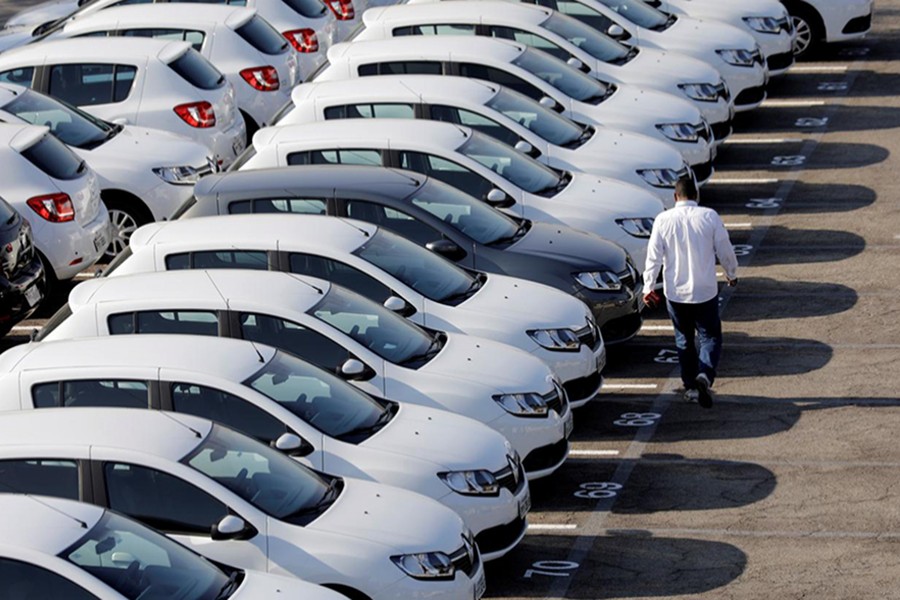 A person walks past cars at a parking lot in Sao Bernardo do Campo, Brazil September 6, 2017 — Reuters/Files