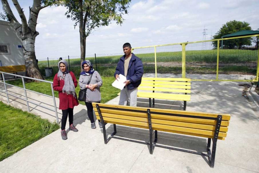 Gholam Arab, right, one of Afghan asylum-seekers who was deported to Serbia in the middle of the night, stands with family members in a centre for asylum-seekers in the northern Serbian city of Subotica, Wednesday, May 8, 2019. Photo: AP