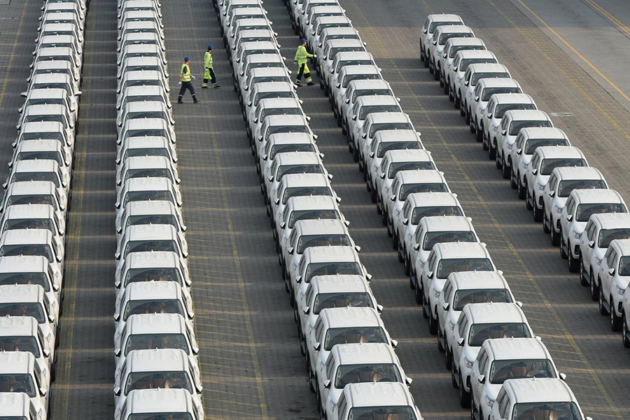 Workers walk among the newly arrived imported Toyota cars at the Shenzhen Dachan Bay Terminals in Guangdong province, China on April 10, 2019 — Reuters/Files