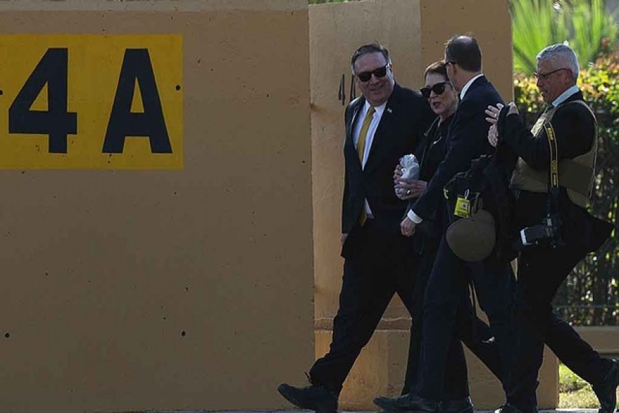 US Secretary of State Mike Pompeo and his wife Susan walk at the US Embassy compound toward the heli pad to catch a helicopter that will transport them to the International Airport, in Baghdad, Iraq, January 9, 2019. - Reuters