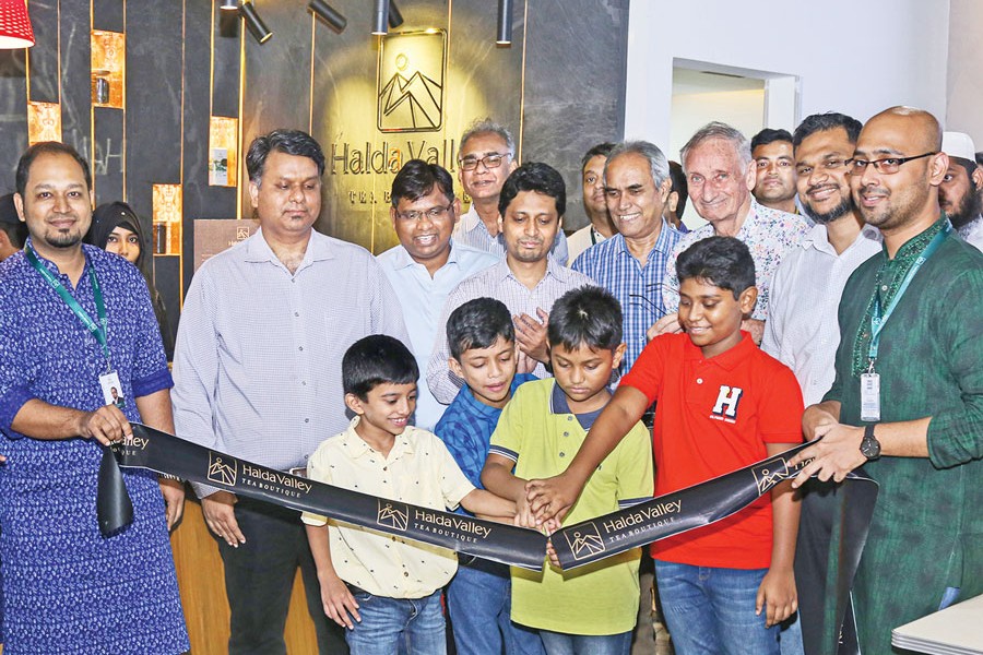 Boys cutting a ribbon to open Halda Valley Tea Boutique at Gulshan Unimart's Chef's Table recently with Managing Director of Halda Valley Food and Beverage Ltd. Shamim Khan, Head of Business Development Ashik Pasha, Brand Manager Azmain Rahman and General Manager of Pedrollo NK Limited Md. Kafil Uddin and Head of Sales Sharif Uddin along with other high officials present