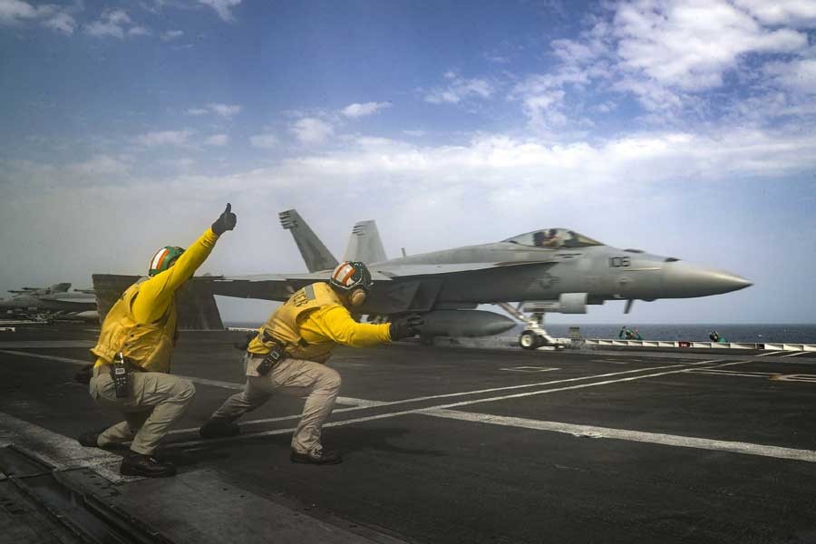 In this Thursday, May 16, 2019 photo released by the US Navy, Lt Nicholas Miller, from Spring, Texas, and Lt Sean Ryan, from Gautier, Miss., launch an F-18 Super Hornet from the deck of the USS Abraham Lincoln aircraft carrier in the Arabian Sea. - AP