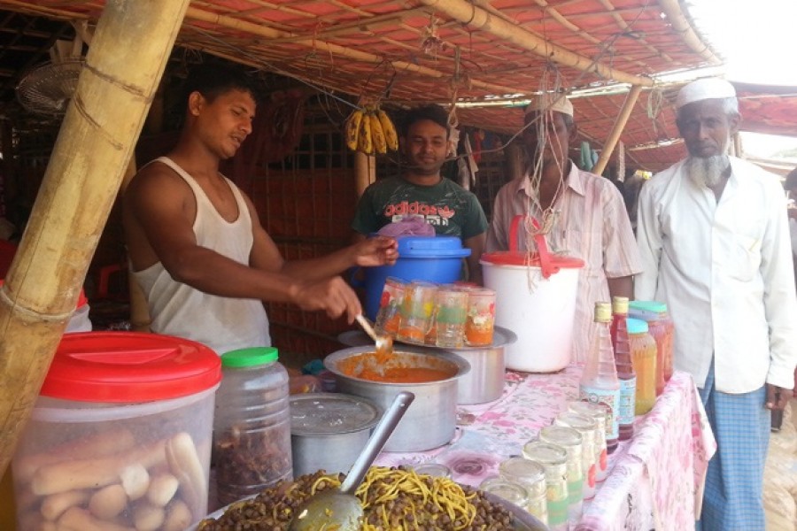 A Rohingya youth selling Iftar items at a shop at Kutupalong Rohingya camp
