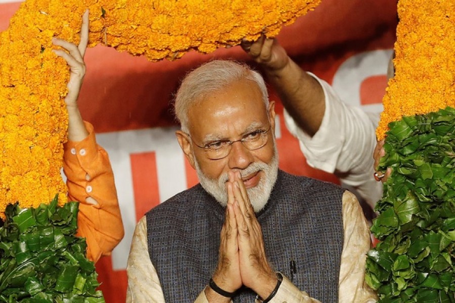 Indian Prime Minister Narendra Modi gestures as he is presented with a garland by Bharatiya Janata Party (BJP) leaders after the election results in New Delhi, India, May 23, 2019. Reuters