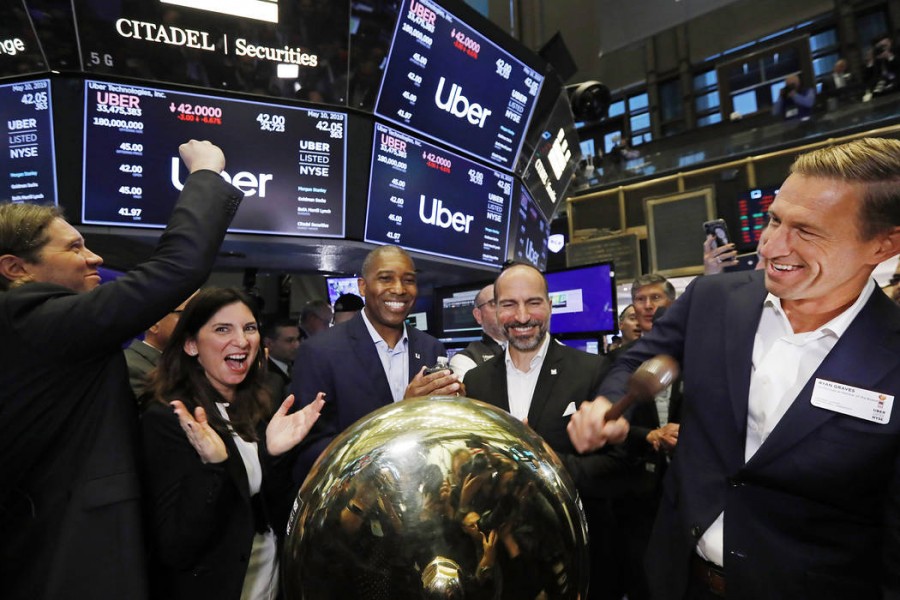 In this Friday, May 10, 2019 file photo, Uber board member Ryan Graves, right, rings a ceremonial bell as the company's stock opens for trading during its initial public offering at the New York Stock Exchange - AP