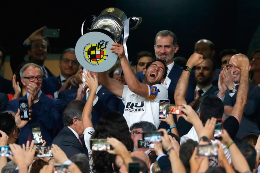 Valencia captain Daniel Parejo holds the trophy aloft after winning the Copa del Rey final between Valencia CF and FC Barcelona at the Benito Villamarin stadium in Seville, Spain on May 25, 2019 — AP photo