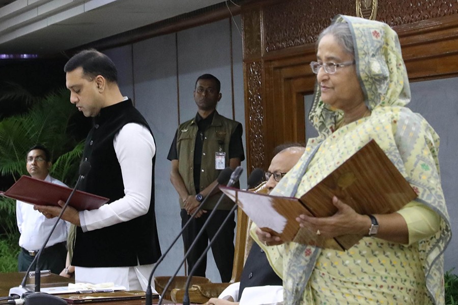 Prime Minister Sheikh Hasina administering the oath to newly-elected Mayor of Mymensingh City Corporation Ekramul Haque Titu at her office in the capital on Monday — Focus Bangla photo