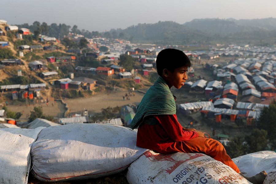 A Rohingya refugee child looks at the vill from a hill at Unchiparang refugee camp, near Cox's Bazar, Bangladesh on January 11, 2018 — Reuters/Files