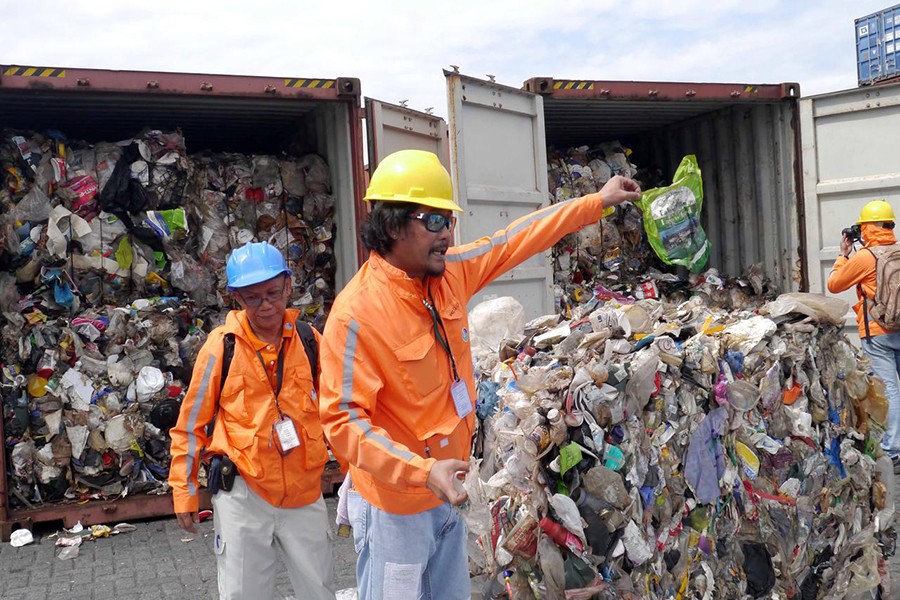 Philippine customs officials inspect cargo containers containing tonnes of garbage shipped by Canada at Manila port on November 10, 2014. Mandatory credit BAN Toxics/Handout via Reuters