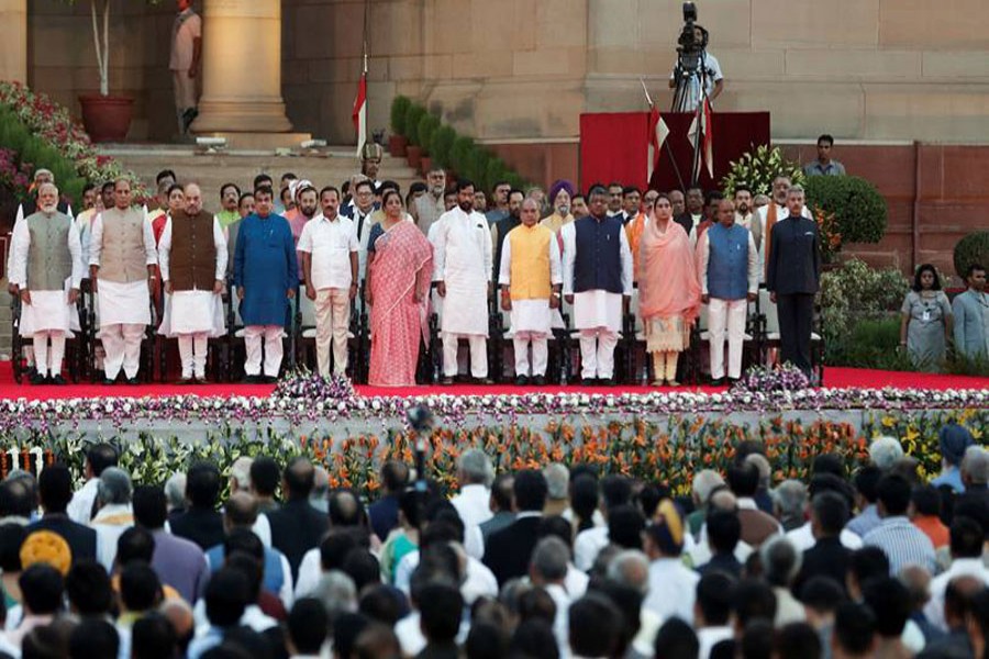 Prime Minister Narendra Modi and members of his cabinet stand for national anthem during a swearing-in ceremony at the presidential palace in New Delhi, May 30, 2019. Reuters