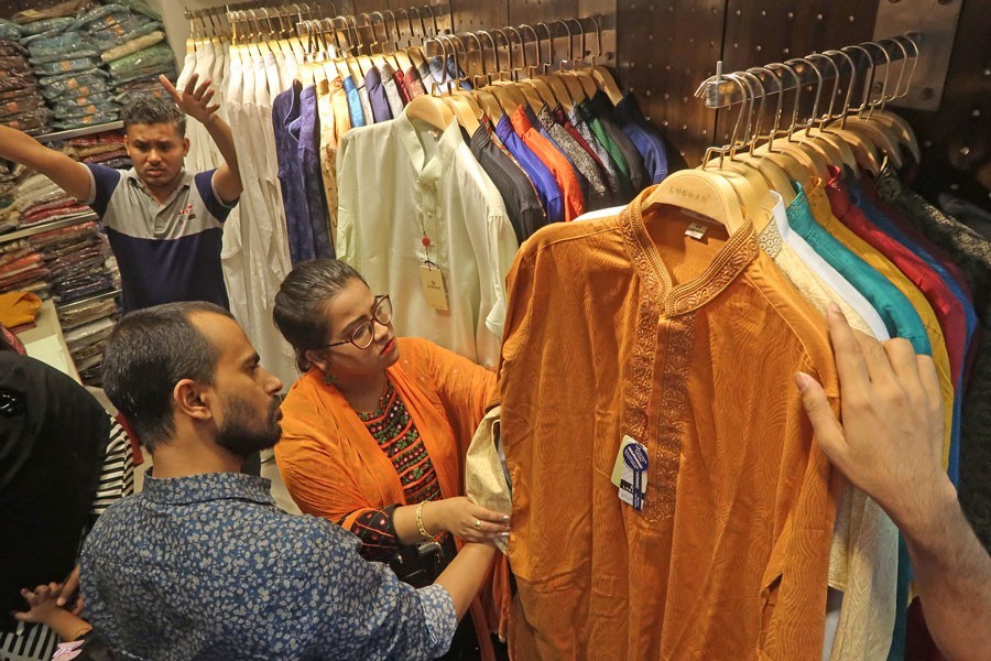 Eid shoppers looking for their choice of panjabis at a city shopping mall on Sunday — FE photo