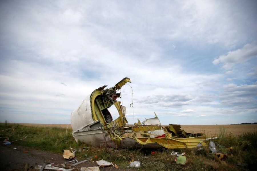 A part of the wreckage is seen at the crash site of the Malaysia Airlines Flight MH17 near the village of Hrabove (Grabovo), in the Donetsk region July 21, 2014 - REUTERS/Maxim Zmeyev/File Photo