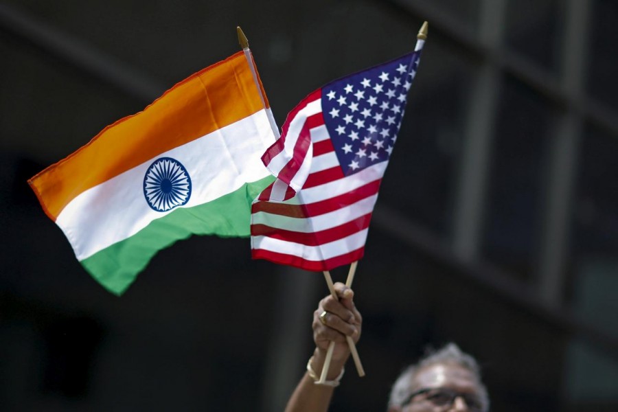 A man holds flags of India and the US while people take part in the 35th India Day Parade in New York, US, August 16, 2015. Reuters/Files