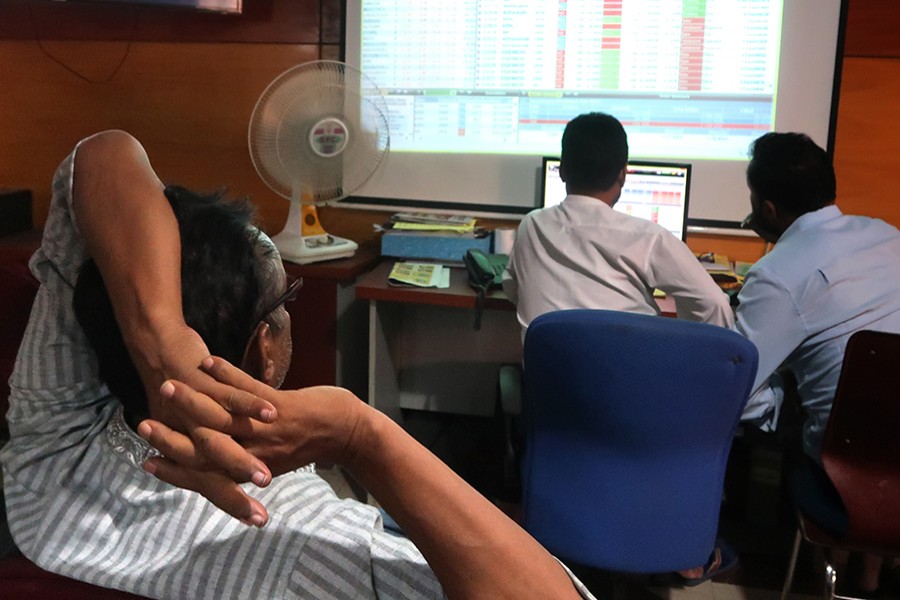 Investors monitoring stock price movements on computer screens at a brockerage house in the capital city — FE/Files