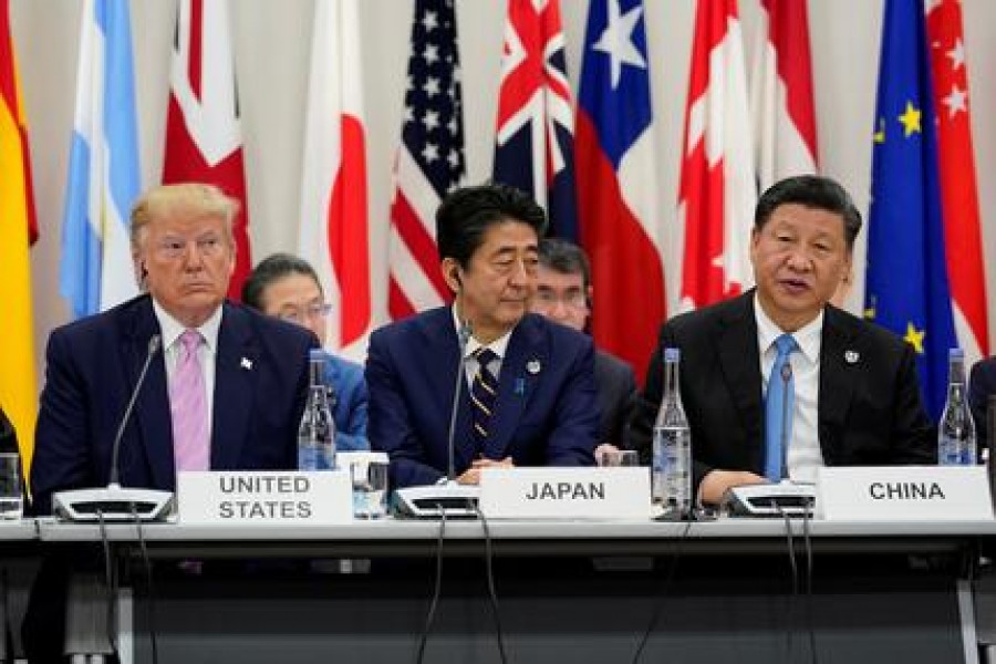 Japan's Prime Minister Shinzo Abe is flanked by US President Donald Trump and China's President Xi Jinping during a meeting at the G20 leaders summit in Osaka, Japan, June 28, 2019. Reuters