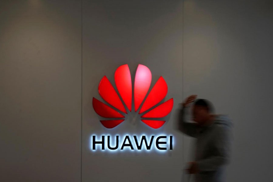 A man walks by a Huawei logo at a shopping mall in Shanghai, China December 6, 2018. Reuters/Files