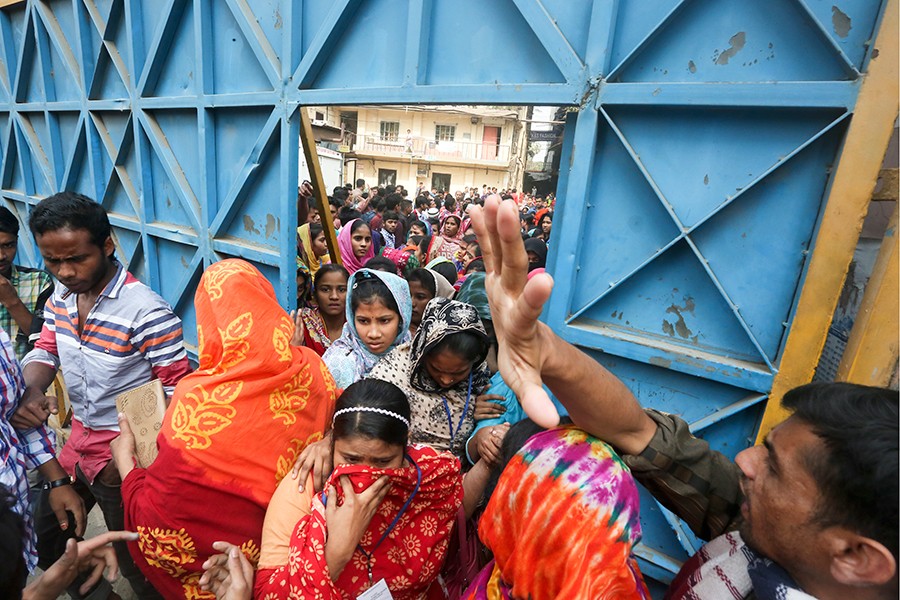 Workers of a garment factory in Dhaka seen joining their workplace, ending their mass protests,  after a revision in the wage structure — FE/files