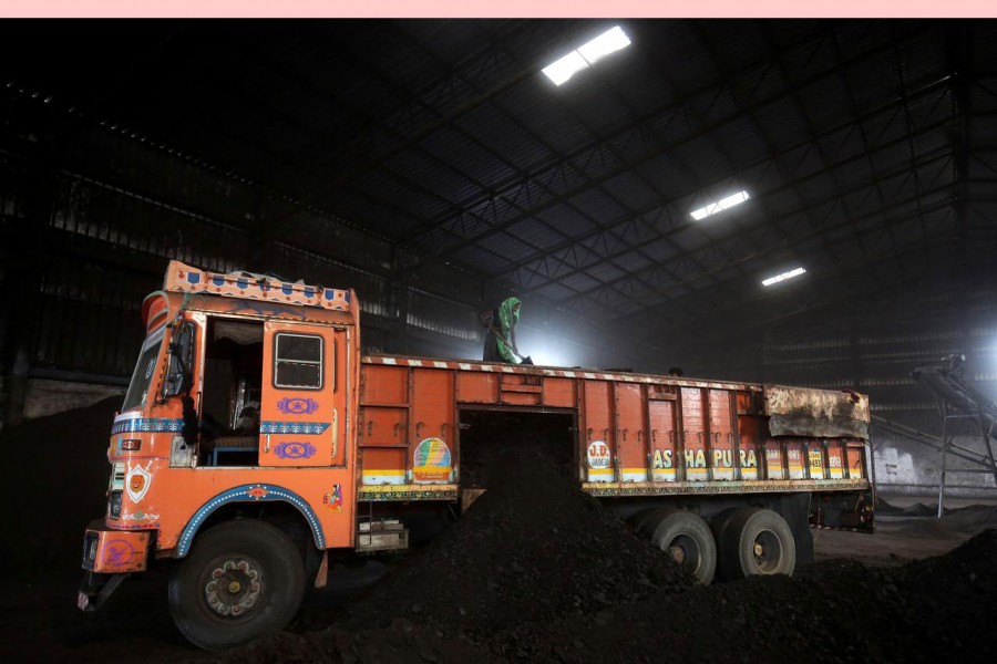 A worker shovels coal in a supply truck at a yard on the outskirts of Ahmedabad, India, October 25, 2018. Reuters/File Photo