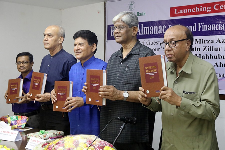Dignitaries displaying copies of the book - 'Banking Almanac: Banks and Financial Institutions of Bangladesh 2017' - at its launching programme at National Press Club in the capital on Saturday — FE Photo