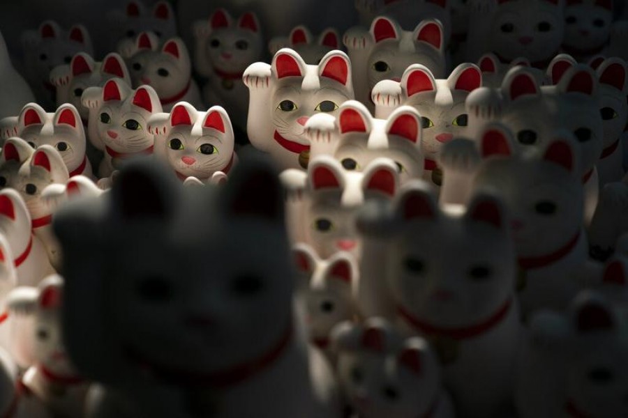 In this June 25, 2019, photo, beckoning cat figurines are on display at Gotokuji Temple in Tokyo - JAE C HONG/AP