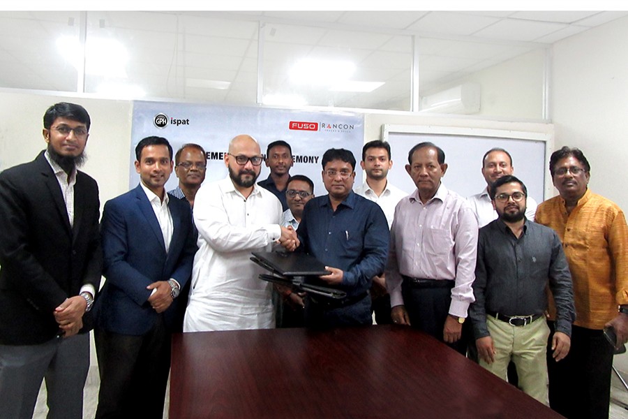 Shawn Hakim (left), Divisional Director of Rancon Trucks & Buses Limited (RTBL) and Mohammad Almas Shimul, Additional Managing Director of GPH Ispat Limited seen exchanging documents at the signing ceremony