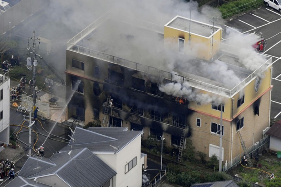 An aerial view shows firefighters battling fires at the site where a man started a fire after spraying a liquid at a three-story studio of Kyoto Animation Co. in Kyoto, western Japan, in this photo taken by Kyodo, on July 18, 2019. Mandatory credit: Kyodo via Reuters