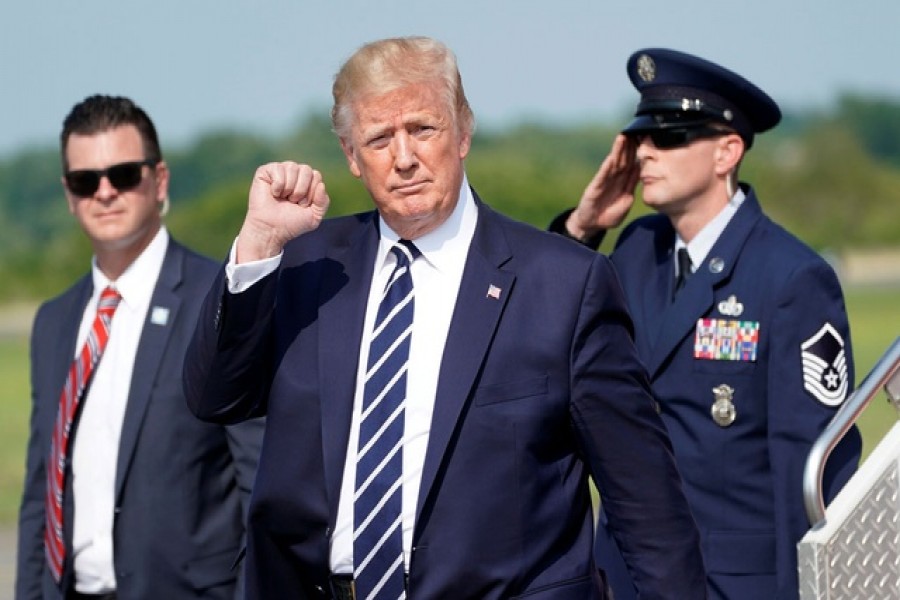 US President Donald Trump pumps his fist as he arrives in Morristown to spend the weekend at his golf club in nearby Bedminster, New Jersey, US, July 19, 2019. Reuters