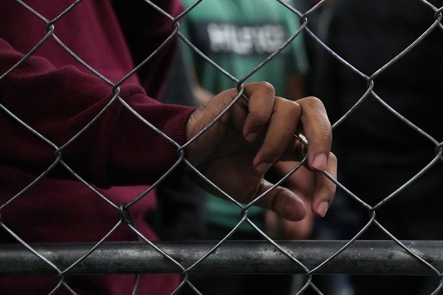 Single-adult male detainees wait along a fence inside a Border Patrol station in McAllen, Texas, US on July 12, 2019 — Reuters photo