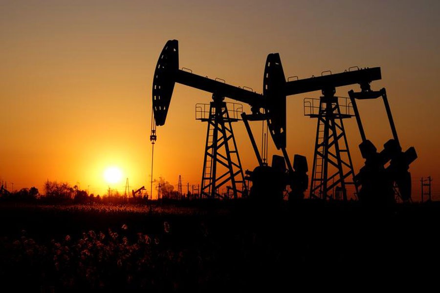 Pumpjacks are seen against the setting sun at the Daqing oil field in Heilongjiang province, China             	—  Reuters