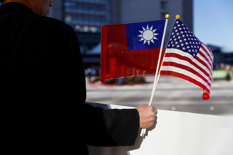 A demonstrator holds flags of Taiwan and the United States in support of Taiwanese President Tsai Ing-wen during an stop-over after her visit to Latin America in Burlingame, California, US on January 14, 2017 — Reuters/Files