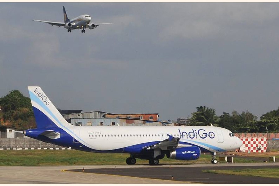 An IndiGo Airbus A320 taxis as a Jet Airways Boeing 737-800 approaches Chhatrapati Shivaji International Airport in western India
