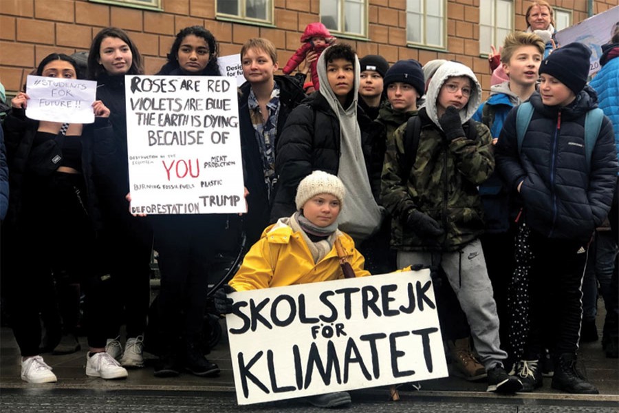 Swedish 16-year-old environmental activist Greta Thunberg (in the front) attends a protest next to Sweden's parliament in Stockholm, Sweden, on March 08, 2019. The sign reads 'School strike for the climate'. 	—Photo: Reuters 'A young Swedish girl, Greta Thunberg, has done more with her stubbornness to raise awareness about impending climate change than the entire political system. Even Trump (albeit for electoral reasons) has now declared that climate change is important.'
