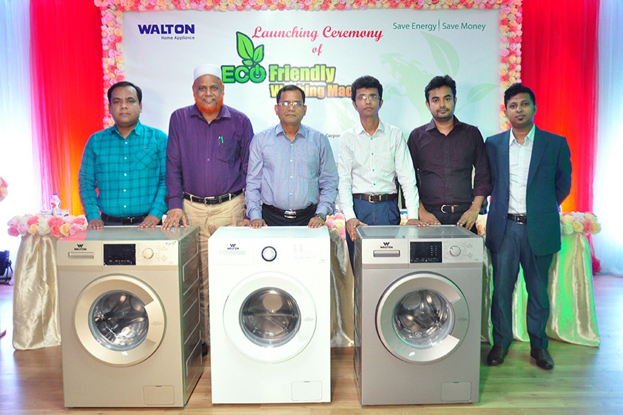 Walton higher officials pose for a photograph during the launching ceremony of the automatic washing machines