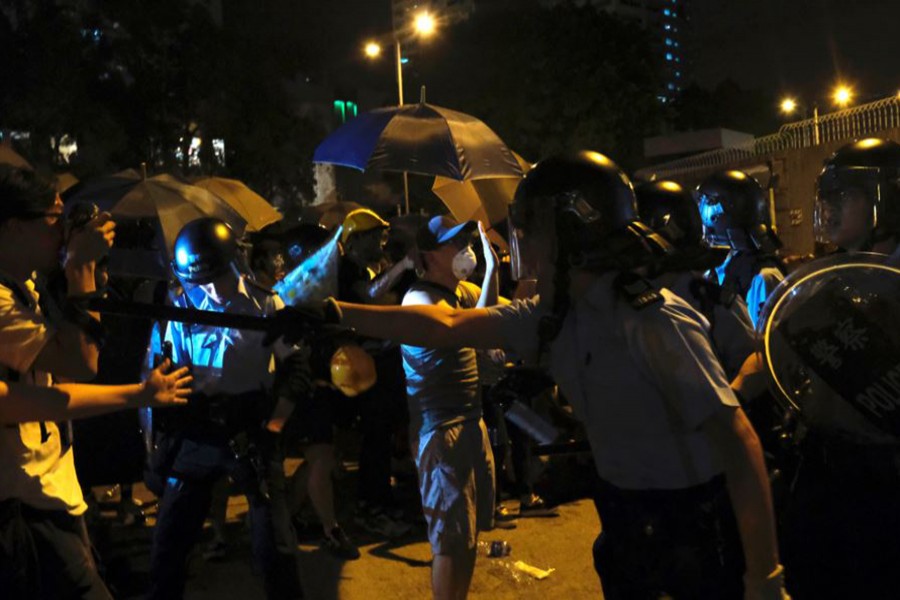 Police officers shout towards anti-extradition bill protesters who surrounded a police station where detained protesters are being held during clashes in Hong Kong, China on July on 30, 2019 — Reuters photo