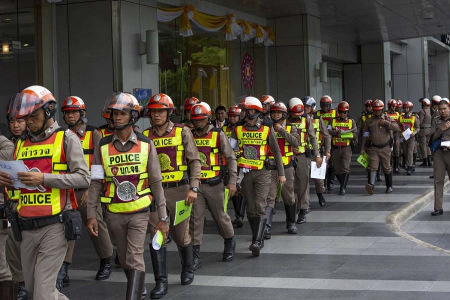 Police officers assigned to control traffic walk outside the venue scheduled to hold the Asean annual leaders' summit in Bangkok (AP Photo)