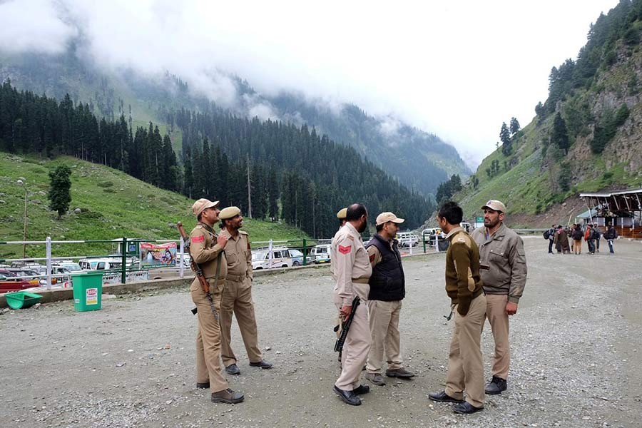 Indian policemen standing at a base camp for a Hindu pilgrimage to the holy cave of Amarnath, where Hindu worship an ice stalagmite that they believe to be the symbol of Lord Shiva, near Pahalgam, in the Kashmir region on July 27. -Reuters Photo