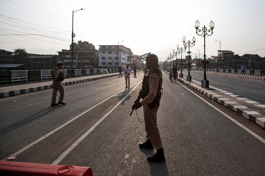 Indian security personnel stand guard on a deserted road during restrictions in Srinagar, on August 5, 2019 — Reuters photo