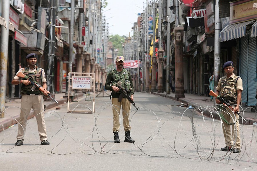 Indian security personnel stand guard along a deserted street during restrictions in Jammu on August 5, 2019 — Reuters photo